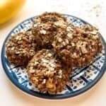 baked cookies on blue plate with bananas in background