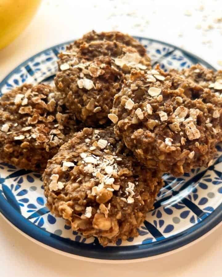 baked cookies on blue plate with bananas in background