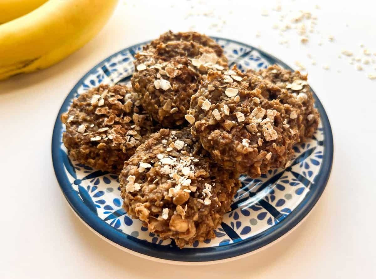 baked cookies on blue plate with bananas in background