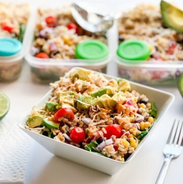 Southwest Chipotle-Lime Chicken Salad in a bowl with meal prep containers in background.