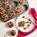 Blueberry oatmeal muffins in tin and white plate