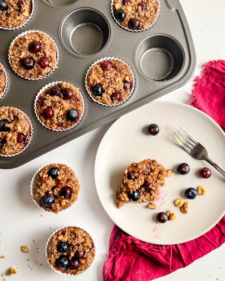 Blueberry oatmeal muffins in tin and white plate