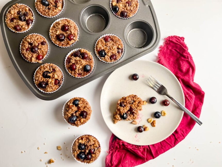 Blueberry oatmeal muffins in tin and white plate