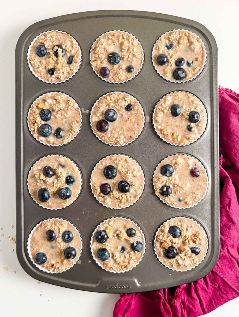 oatmeal batter in muffin tins with blueberries