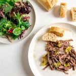 mama's italian beef with baguette slices and green salad